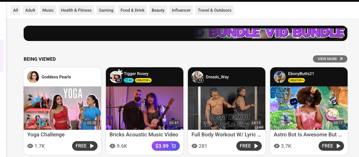 ManyVids logged-out browse view showing category filters and a Being Viewed row of video cards with Free and $3.99 purchase buttons